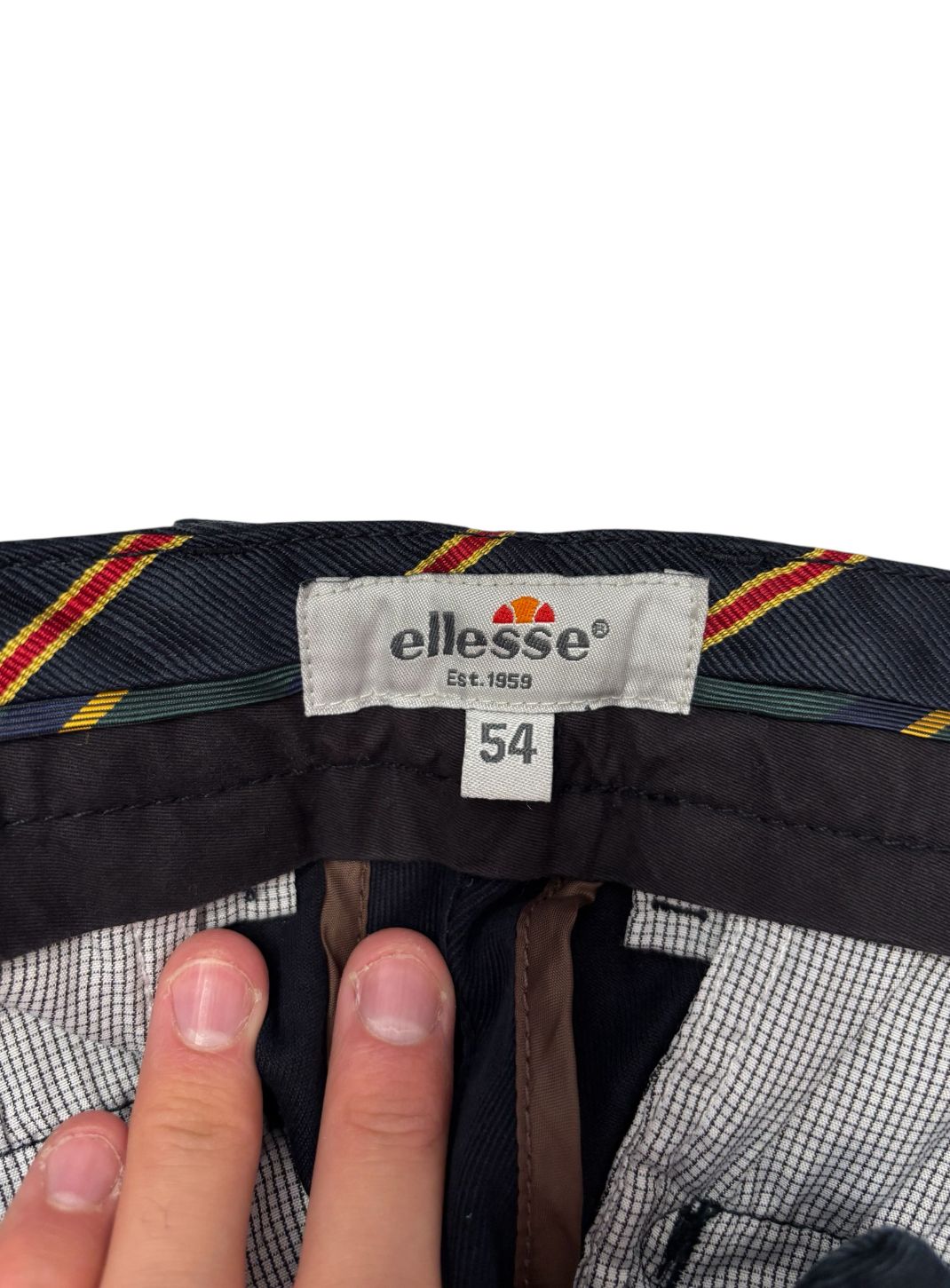 Pantalone classico con bottone decentrato a contrasto